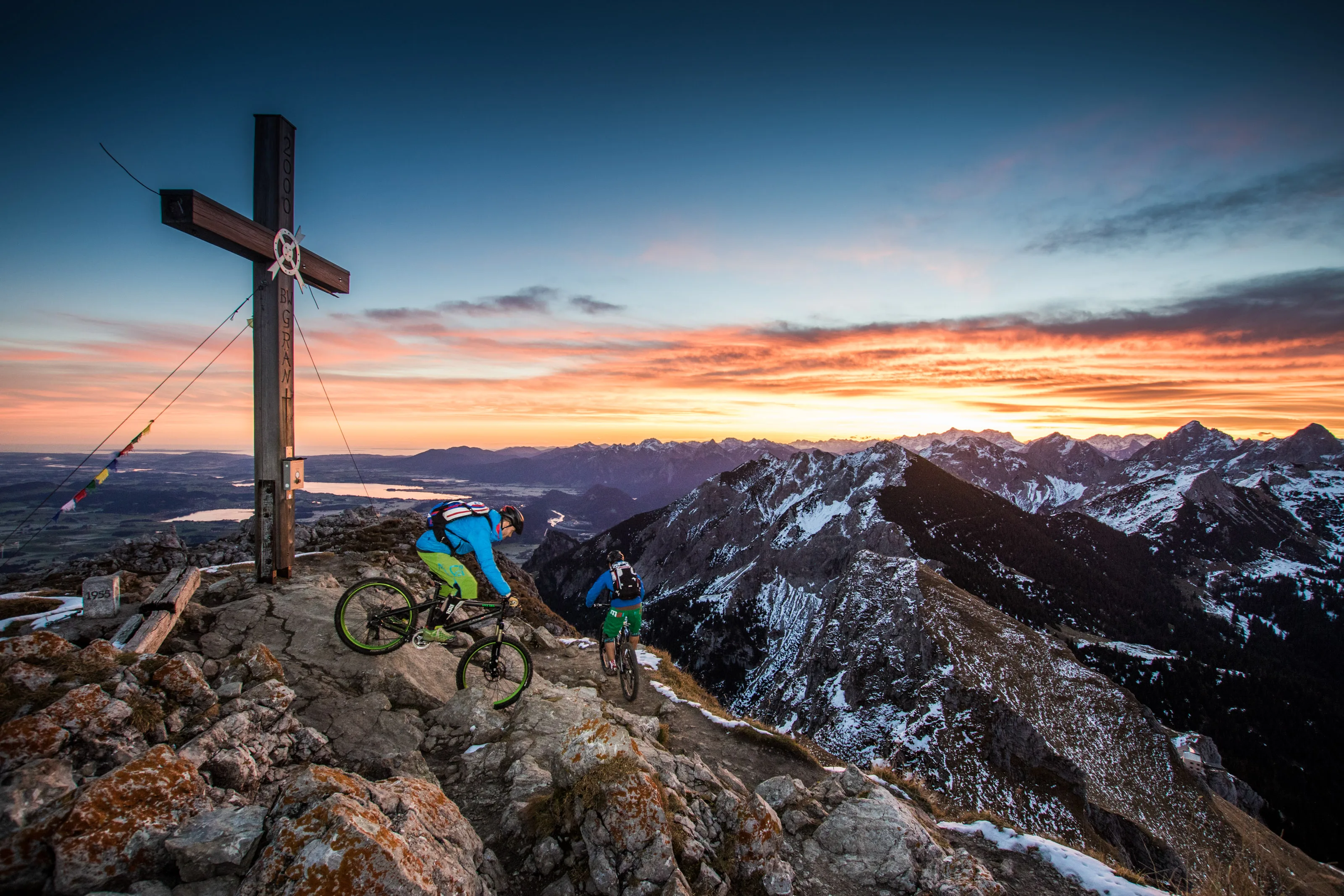 Florian Häusler und Robert Härle fahren mit Mountainbikes vom Gipfel ins Tannheimer Tal ab.