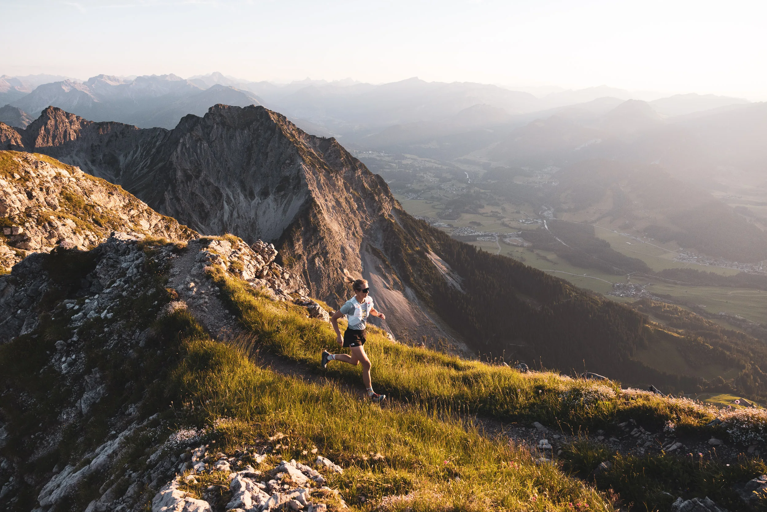 Ronja Morell läuft im Abendlicht über einen Hang mit Blick ins Tal